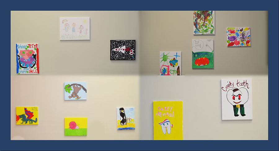 The image shows a gallery wall with an assortment of colorful artwork, including paintings, drawings, and photographs, displayed on a white background.
